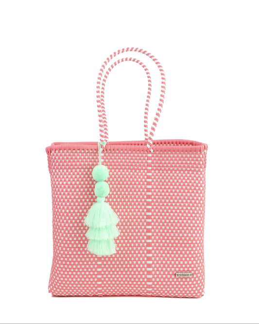 A pink and white checkered jumbo tote with a tassel, hand-woven and made of plastic.